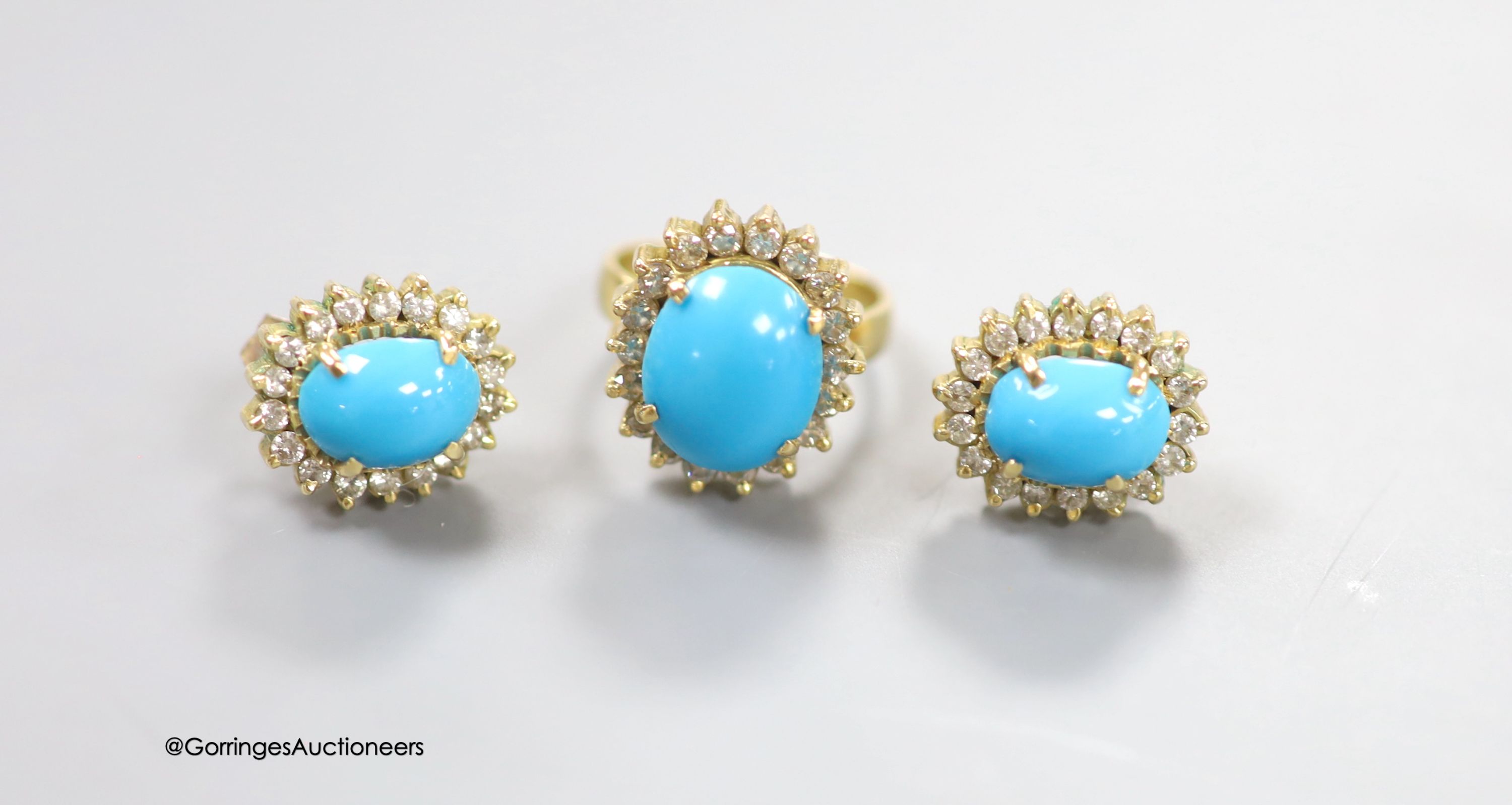 A modern yellow metal, turquoise and diamond set oval dress ring, size G and a pair of matching ear studs, 14mm, gross 14.6 grams.